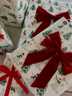 several wrapped presents with red bows on them