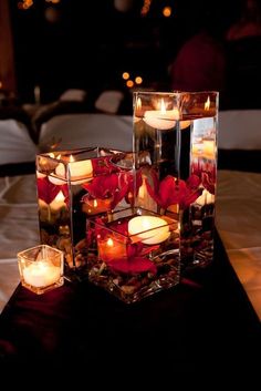 candles are arranged in glass cubes on a table