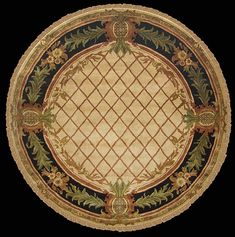 an ornately decorated gold plate with green and yellow designs on the edges, set against a black background