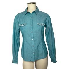 New With Tags Panhandle Womens Aztec Embroidery Geo Printed Long Sleeves Western Snap Shirts Designed In Usa Rock & Roll Cowgirl Long Sleeve Embroidery Spread Collar Snap Buttons Closure Snap Flap Pockets 97% Cotton, 3% Spandex Color: Turquoise Size: S Pit To Pit 19” Length 24/5” S7 Western Blue Button-up Top, Western Style Blue Tops For Spring, Turquoise Long Sleeve Cotton Top, Casual Turquoise Cotton Blouse, Turquoise Cotton Blouse, Cowgirl T Shirt, Aztec Embroidery, Lace Knit Top, Boho Pullover