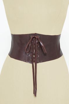 Wide stretch belt handmade in our atelier with natural leather in dark brown color. Soft, fashionable and easy to wear. This brown leather corset is tied to the front with leather strips but it has an elastic piece and three snaps on the back that allow you to wear and remove it easily. You can wear it over a blouse, tunics, with blazers, long baggy shirts and all kinds of dresses. This beautiful belt can make your style more casual and sexier: cinch it to your waist and get curves instantly. Se Gothic Brown Corset For Festival, Adjustable Brown Corset Belt With Matching Belt, Brown Fitted Steampunk Corset Belt, Gothic Leather Corset Belt, Brown Leather Corset Belt With Removable Belt, Vintage Brown Corset For Larp, Brown Steampunk Corset Belt, Vintage Fitted Belted Corset Belt, Fitted Brown Corset Belt For Festivals