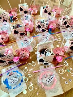 a table topped with lots of pink and blue items on top of a wooden table