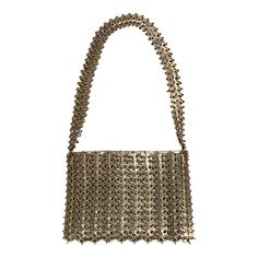 French designer Paco Rabanne is best known for his revolutionary 1968 dresses made from metal discs and rings. This rare handbag soon followed, made from the same materials. The bag has a shoulder strap, an interior silver leather pouch which has a metal zipper, a fabric lining, and the Paco Rabanne label.  It is in excellent condition, with very minor loss to the finish on three of the discs making up the shoulder strap. Measurements; Length 9"  Height 6"  Depth 1.5" Modern Metal Bags For Formal Occasions, Formal Gold Metal Shoulder Bag, Metallic Rectangular Shoulder Bag With Chain Strap, Modern Metal Bags For Parties, Luxury Metal Shoulder Bag For Formal Occasions, Luxury Formal Metal Shoulder Bag, Elegant Silver Bag With Chainmail Detail, Silver Metal Chainmail Bag, Elegant Silver Chainmail Bag