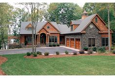 this is an image of a house in the country style with stone and wood accents