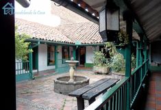 an outdoor courtyard with a fountain and potted plants