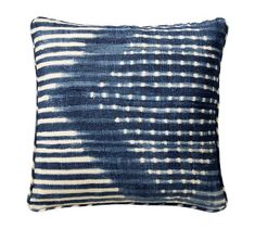 a blue and white pillow that has been dyed with an ombretta pattern on it