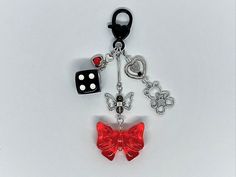 HoloFlora's black & red Dice & Heart Keychain - the perfect decorative touch for keychains, purses, backpacks, lanyards, rearview mirrors, and much much more! 🖤  --- Length: 4  inches ---  ⊹ Made to Order ⊹ --- ˚｡⋆ Gift Box Included ⋆｡˚ --- ♡ This keychain is designed primarily for aesthetic purposes and is not suitable for heavy use. ♡ To preserve its charm & ensure lasting enjoyment, I recommend handling it with care. --- Shop more accessories like this @ HoloFlora ❀ Red Dice, Bow Keychain, Black Y2k, Decorative Bows, Heart Keychain, Rear View Mirror, Rear View, Red And Black, Lanyard