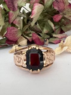 A stunning statement ring that demands attention!  Crafted in luxurious 9ct yellow gold, this signet ring holds a rich, deep dark red rectangular Garnet that instantly draws the eye. It is complemented by intricately embellished shoulders that add  a touch of opulence and sophistication. The tapered shank ensures a comfortable fit, making this ring perfect for those who love to stand out in style.  Whether you're dressing up for a special occasion or simply want to add a little drama to your eve Signet Rings, Statement Dress, Dress Rings, Red And Gold, Ring Box, Signet Ring, Statement Ring, Sterling Silber, Dark Red