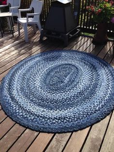 a round rug on a deck with chairs in the background