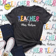 a t - shirt with the words teacher, mrs nelson on it next to jeans and sneakers