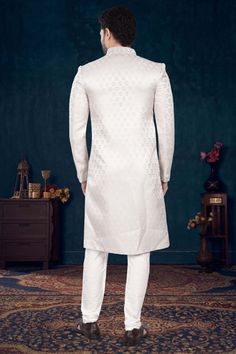 Make a statement with our Mens Sherwani- V2-S041! Perfect for grooms, this sherwani is adorned with elegant cutdana and pearls, adding a touch of sophistication to your wedding day look. Stand out from the crowd and feel like royalty on your special day. Don't miss out on this timeless piece! Elegant Nehru Jacket For Groom At Diwali, Elegant Long Kurta For Groom, Formal Long Sleeve Kurta With Pearl Embroidery, Formal Off White Sherwani With Pallu, Festive Nehru Jacket With Pearl Embroidery For Wedding, Formal Long Sleeve Sherwani With Pearl Embroidery, Formal White Long Kurta, Formal Long White Kurta, Festive Wedding Sherwani With Pearl Embroidery