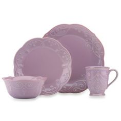 purple dishes and cups are set on a white background