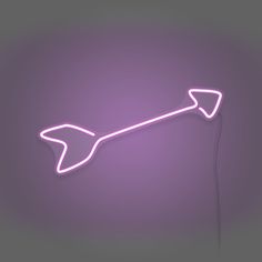 a pink neon sign with an arrow pointing to the right on a purple background that is lit up