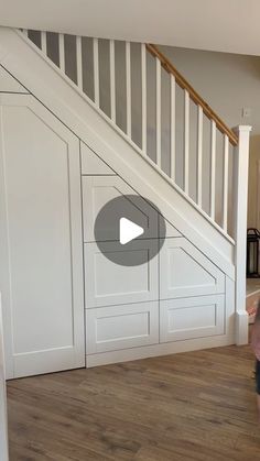 a kid is playing with a ball in the living room next to an open stair case