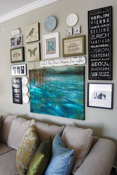 a living room filled with furniture and pictures on the wall