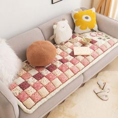 a couch that has some stuffed animals on it