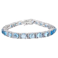 14.49 Carat Blue Topaz and Diamond Tennis Bracelet in sterling silver showcases endlessly sparkling natural blue topaz, weighing 14.49 carat. It measures 7 inches long in length. Blue Topaz stimulate concentration and reduces stress. Designed with perfect round cut blue Topaz set in continuation in prong setting in sterling silver to make you stand out on any occasion or event. The elegant style complements the attire beautifully and is a perfect Engagement Gift, Bridal Shower Gift, Grandma Gift Blue Fine Jewelry Tennis Bracelet For Anniversary, Formal Blue Topaz Blue Bracelets, Formal Blue Topaz Bracelets, Formal Blue Topaz Gemstone Bracelets, Formal Blue Topaz Bracelet, Formal Blue Topaz Gemstone Bracelet, Fine Jewelry Blue Topaz Round Bracelets, Blue Cubic Zirconia Tennis Bracelet With Brilliant Cut, Luxury Blue Bracelets With Gemstone Accents