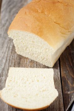 a loaf of white bread sitting on top of a wooden table