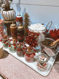 an assortment of holiday treats on a tray with candy canes and marshmallows