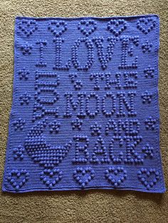 a blue crocheted square with words written on it