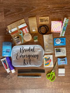 the contents of a bridal emergency kit laid out on top of a wooden table