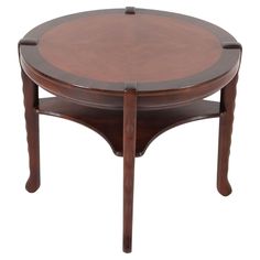 a round wooden table with two legs and a circular center piece on the bottom shelf