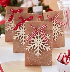 some brown paper bags with snowflakes on them and candy canes in the background