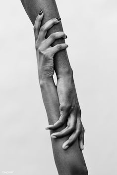 two hands holding each other in the air