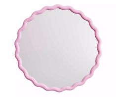 a round mirror with pink scalloped edges on a white background, reflecting light