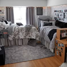 a bedroom decorated in gray and white with pictures on the wall