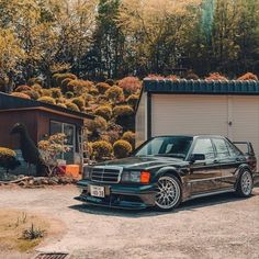 a black car parked in front of a garage