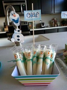 there are some toothbrushes in a bowl on the counter top with a sign