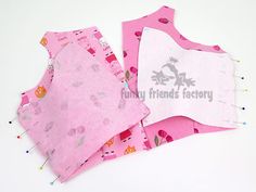 three pieces of pink and white fabric sitting next to each other on top of a table