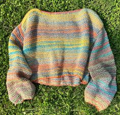 This vibrant, hand-knit sweater features a mix of colorful rainbow stripes with a relaxed, oversized fit. Made with breathable, lightweight yarn, it's perfect for layering over casual outfits or wearing as a stylish beach cover-up. The loose-knit design and wide balloon sleeves give it a cozy, boho vibe, making it a must-have for cool summer evenings or breezy fall days. Ideal for those seeking unique, artisan knitwear that blends comfort with standout style. Perfect for beach days, casual outings, or adding a pop of color to any look. One Size; small/medium Fit: Relaxed, Slightly oversized. Cropped length hits just above the waist. Loose, boxy shape. Features: Handmade, soft acrylic yarn, wide crew neckline, wide balloon sleeves. ❤Due to the handmade nature of this sweater, each piece is Colorful Oversized Sweater, Casual Beach Style, Cozy Boho, Boho Sweater, Rainbow Sweater, Style Sweater, Fall Days, Loose Knit, Hand Knitted Sweaters