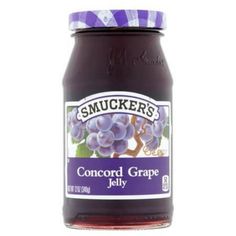 a jar of purple grape jelly on a white background with the words smucker's concord grape jelly