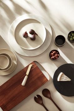 the table is set with plates, bowls and utensils