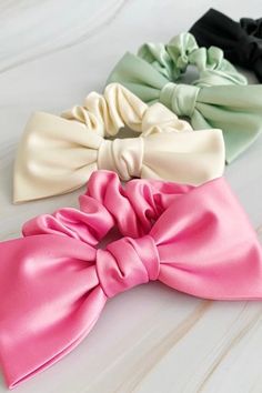 Our Satin Bow Tie Hair Scrunch is made from high quality satin, this scrunchie adds a charming and sophisticated detail to any hairstyle. Perfect for both casual and formal events, this scrunch is a must-have for a polished and stylish appearance.Dimensions: The bow is approximately 5.5" x 3" x 1"Made In: ChinaMaterial Composition: high quality satin