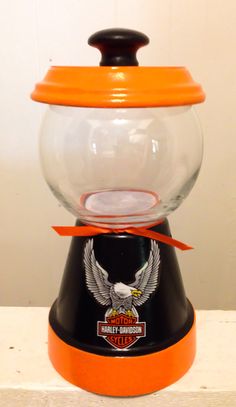 an orange and black gumper dispenser sitting on top of a counter