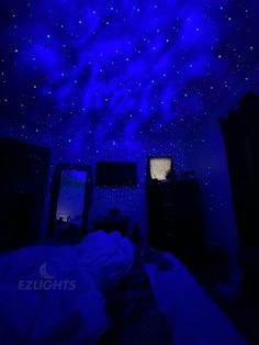 a bedroom with stars in the night sky