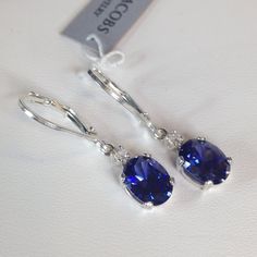 Beautiful Tanzanite* & White Sapphire Leverback Earrings * Oval Cut Tanzanites* Measure 8mm x6mm * Brilliant Cut White Sapphire Accents * 2.3cts total Gemstone weight * Leverback Fasteners * Solid Sterling Silver Hallmarked & Gift Ready! Matching Pendant Necklace and/or Ring also Available! *Tanzanite is one of very few gemstones that cannot be grown in a Lab, however, these Laboratory Grown Simulate Stones are optically identical to a natural Tanzanite in color and are just as hard but, do not December Stone, Trending Jewelry, Tanzanite Diamond, Fine Art Jewelry, Blue Tanzanite, Leverback Earrings, Natural Tanzanite, Drop Dangle Earrings, Diamond Drops