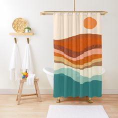 a bathroom with a shower curtain that has different colors on it and a white rug