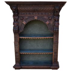 an ornate wooden bookcase with shelves on the top and bottom, decorated with intricate carvings