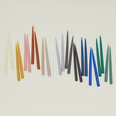 several different colored candles lined up in a row