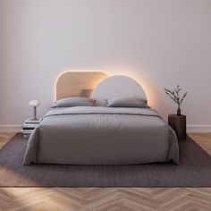 a bedroom with a bed, nightstand and lamp