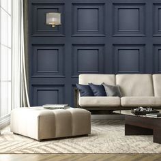 a living room with dark blue walls and white furniture in the center, along with a coffee table