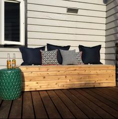 a wooden bench sitting on top of a wooden deck