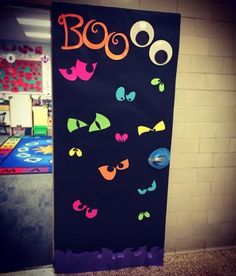 a door decorated with halloween decorations and the words boo on it