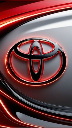 the front end of a toyota car with red lights shining on it's hood