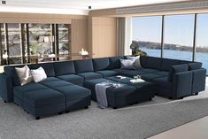 a living room with a large blue sectional couch and ottoman in front of a window