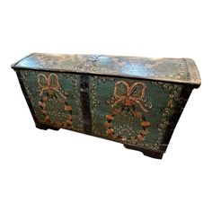 an old wooden chest with decorative designs on it